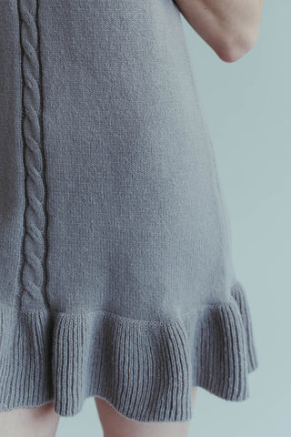 Gray knit skirt with textured waistband on a light background