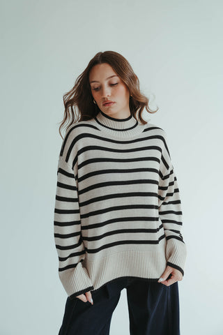 1.	“Oversized cream and black striped mock neck sweater for women”
	2.	“Cozy striped knit pullover in cream and black”
	3.	“Women’s oversized striped sweater, cream and black, mock neck”
	4.	“Casual chic black and cream striped knit sweater”