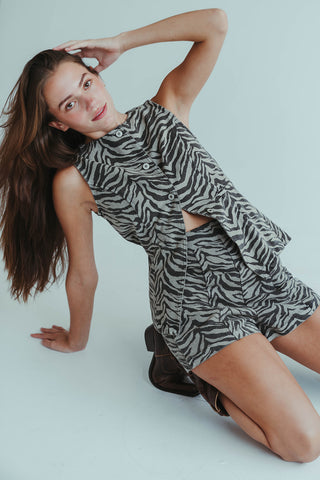 Woman wearing a zebra print dress on a white background