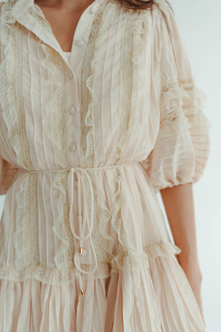 Beige lace dress with puff sleeves on a white background