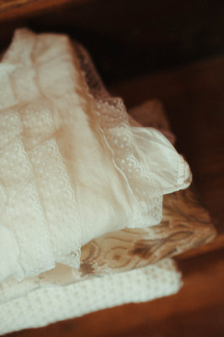 Close-up of lace fabric on a wooden surface